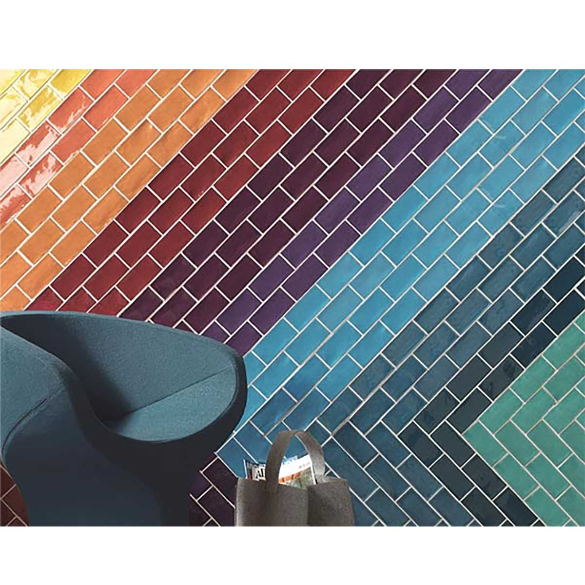 Colorful Kaleidoscope tiled wall with a blue chair and bag in front