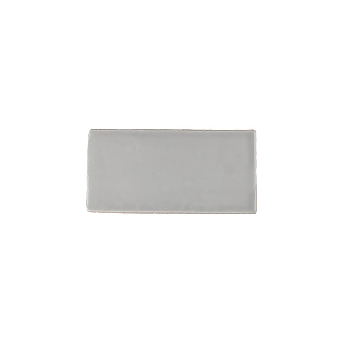 Glossy grey ceramic subway tile with handcrafted Spanish artisan detailing