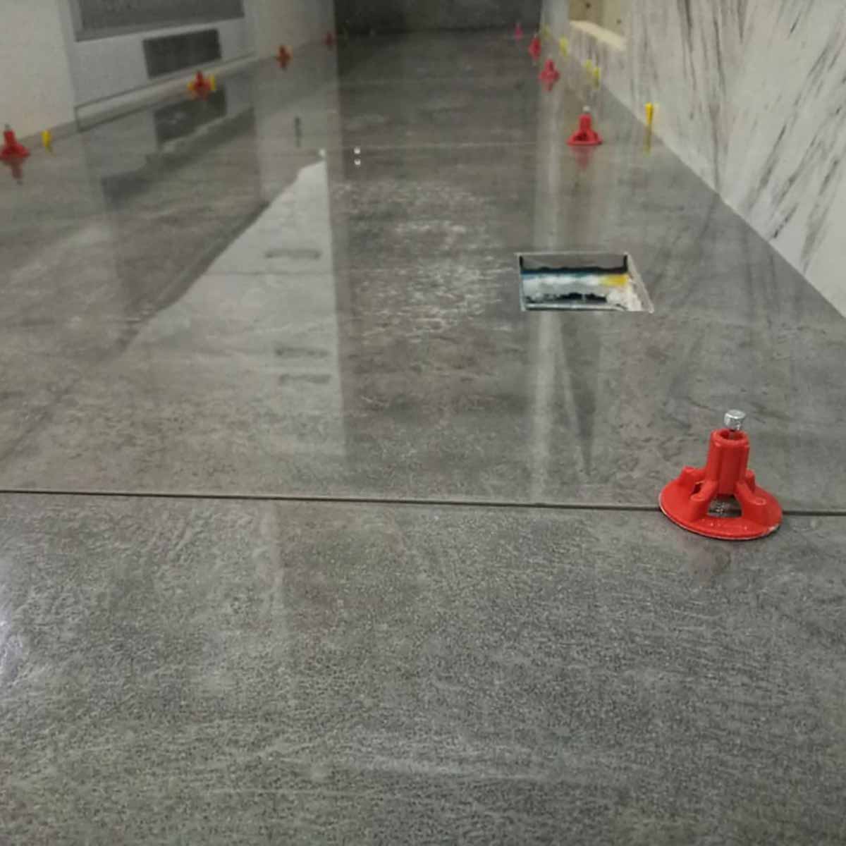 ATR Tile Leveling System use in Indoor Gray Porcelain Tile showing the spindle attached in a Cross Pattern