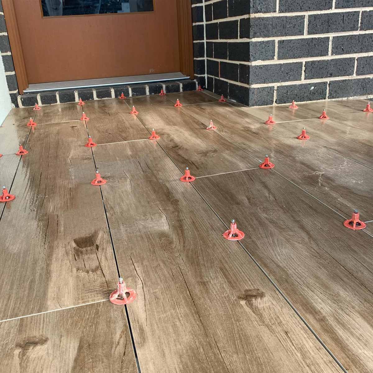 Wooden flooring with ATR Tile Leveling System T Shape Profile Spacers in a brick Pattern