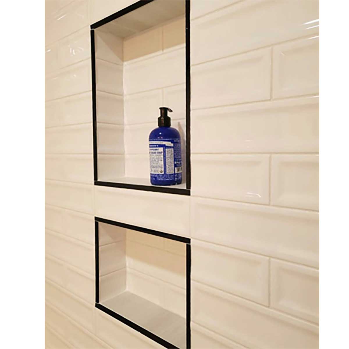 Shower niche with shampoo bottle installed over Cream 3x12 Glossy Ceramic Groove Wall Tile