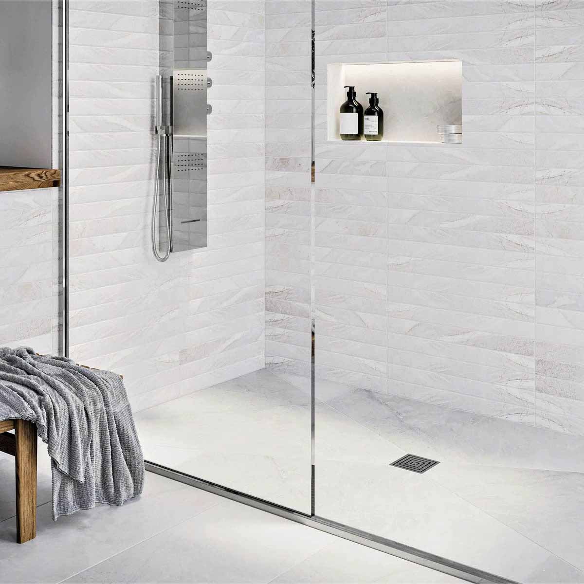 Modern bathroom with glass shower enclosure, white wall tiles, and Polished Chrome fixtures with Ebbe Drains Unique Square Shower Drain Grate - Frames