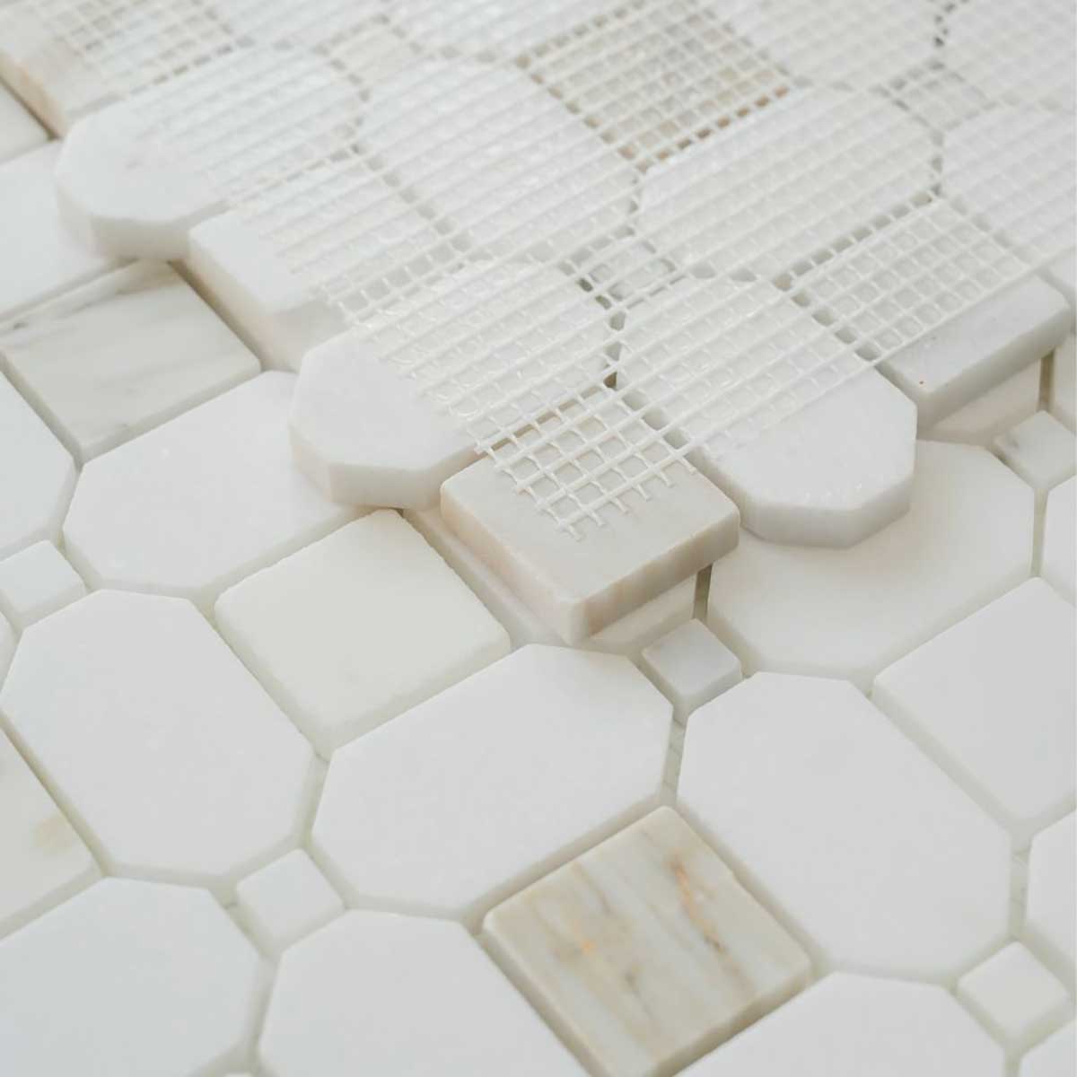 Honed marble mosaic backsplash tile with white and gold veining