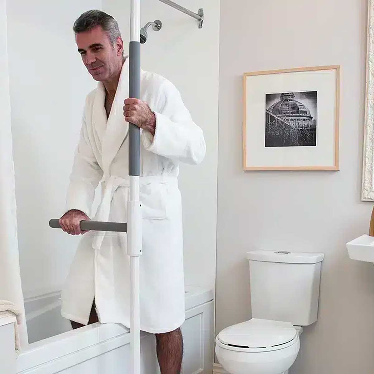Mobility assistance pole with rotating support arm in residential bedroom