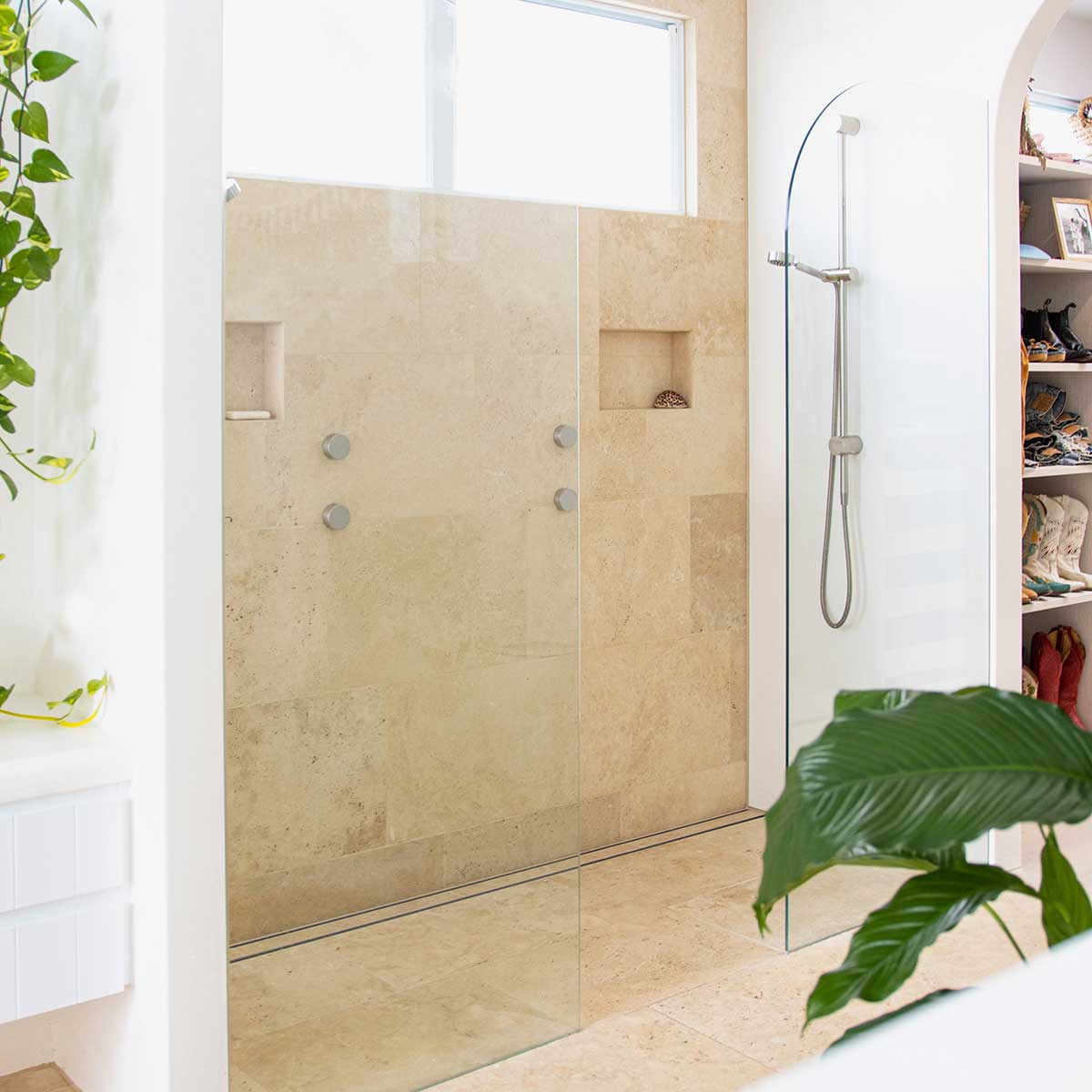 Close-up of a tiled floor with Lauxes Grates Custom shower drain Tile Insert in Silk Silver finish