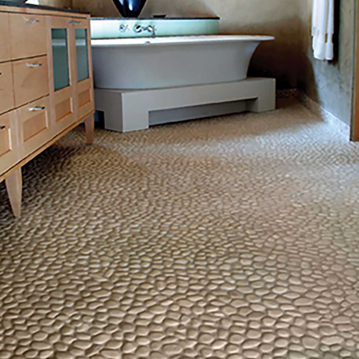 Light cream pebble flooring adding texture and warmth to bathroom designs
