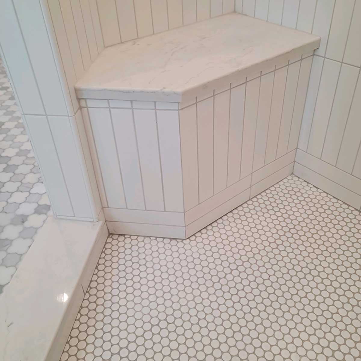 Waterproof shower seat integrated into tiled shower wall for comfortable seating