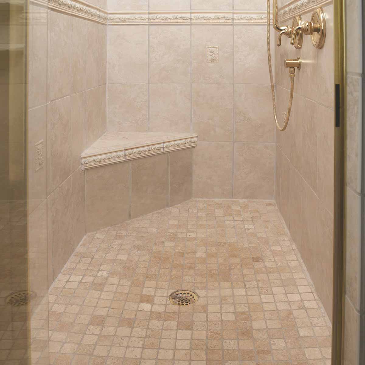 PreFormed Ready to Tile Shower Pan got installed showing in a Beige tiled shower with gold fixtures