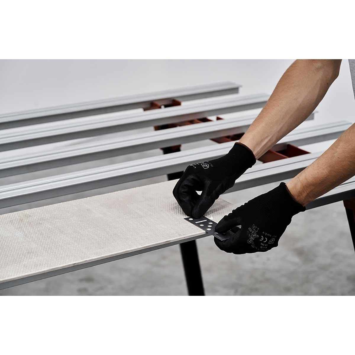 Person using a Rai Fix hook to install large format tile