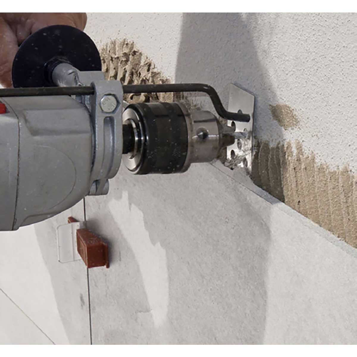 Person using a Rai Fix hook to install large format tile