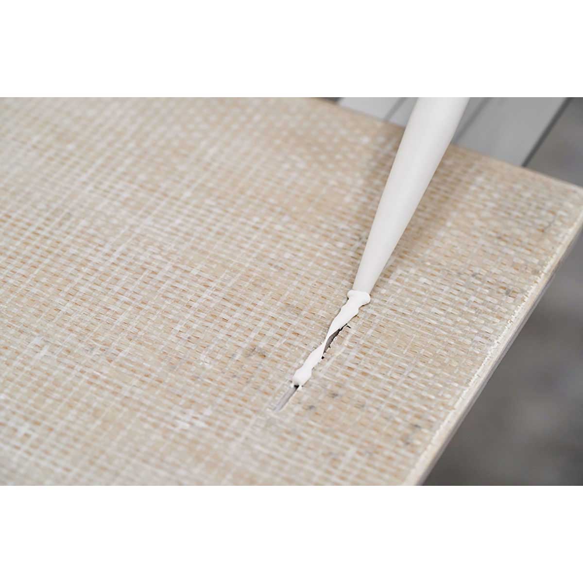 Person using a Rai Fix hook to install large format tile