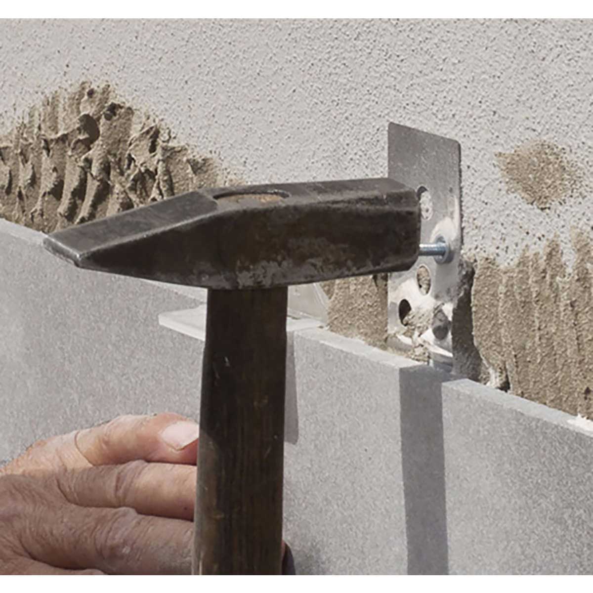 Person using a Rai Fix hook to install large format tile