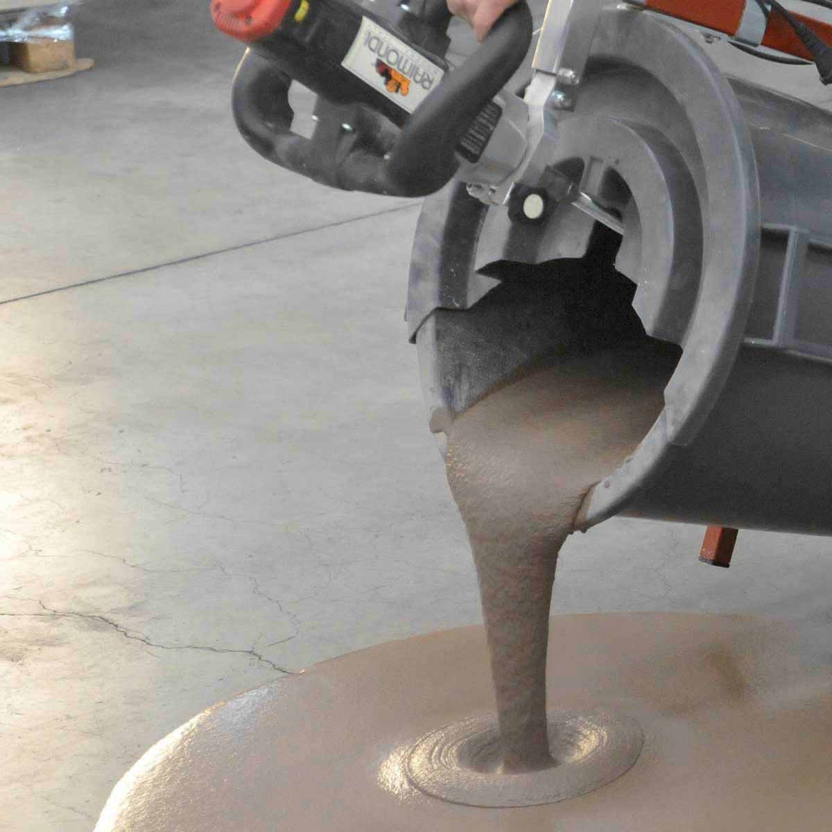 Raimondi Fluid Mixer With Paddle - MXFMS Concrete mixer with a bucket of wet concrete