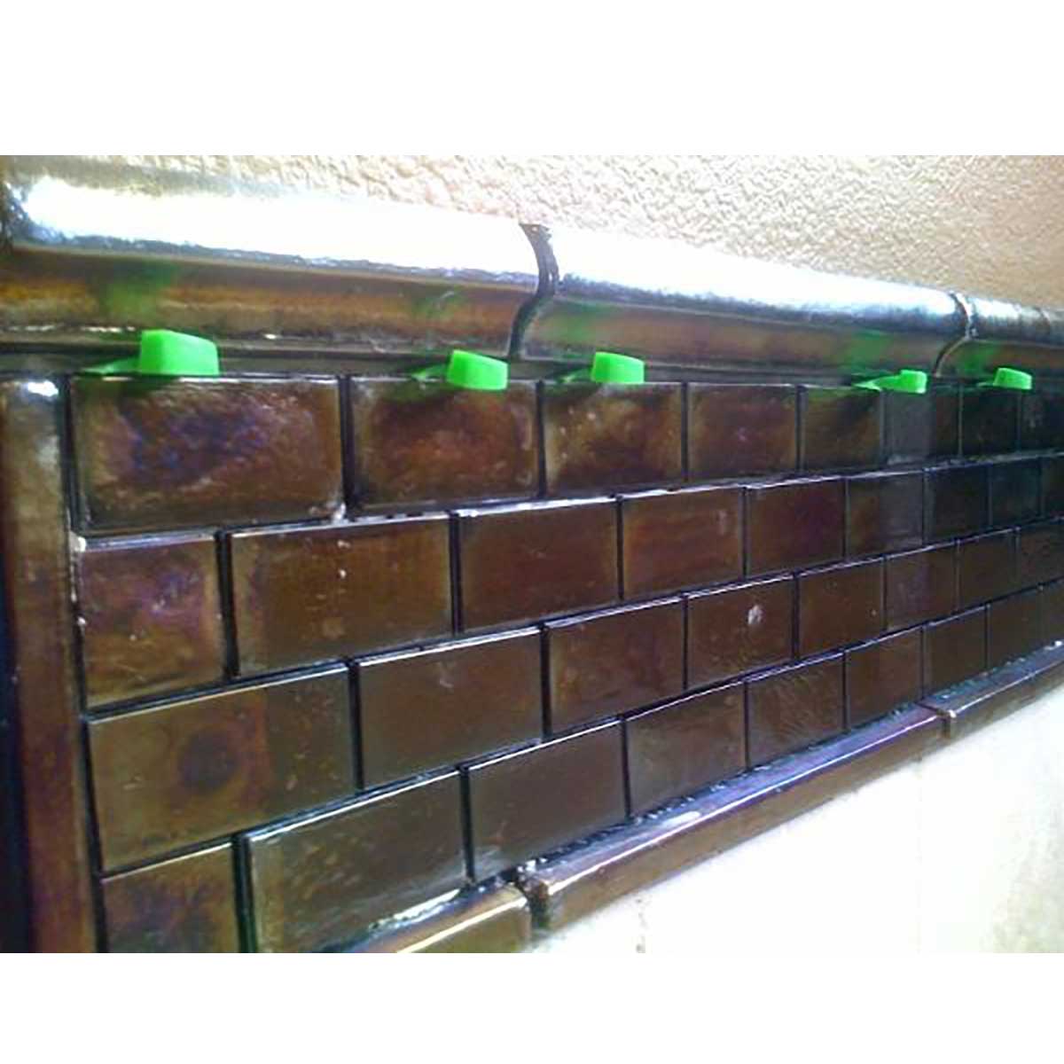 Professional Tile Spacer Wedges install in between glass tile and bullnose on a wall