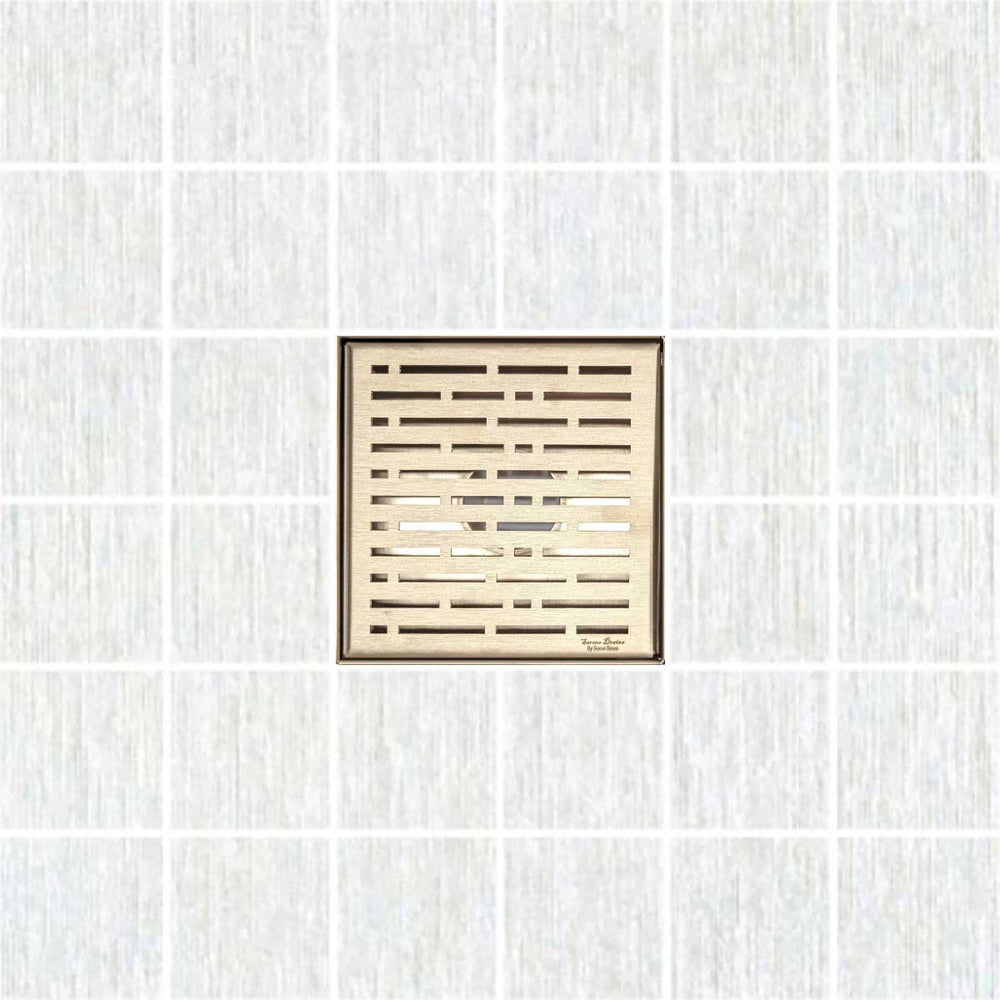 Decorative square shower drain cover with a textured pattern on a white background