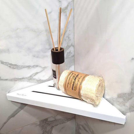 SereneDrains Stainless Steel Matte White Corner shower shelf mounted on a marble wall