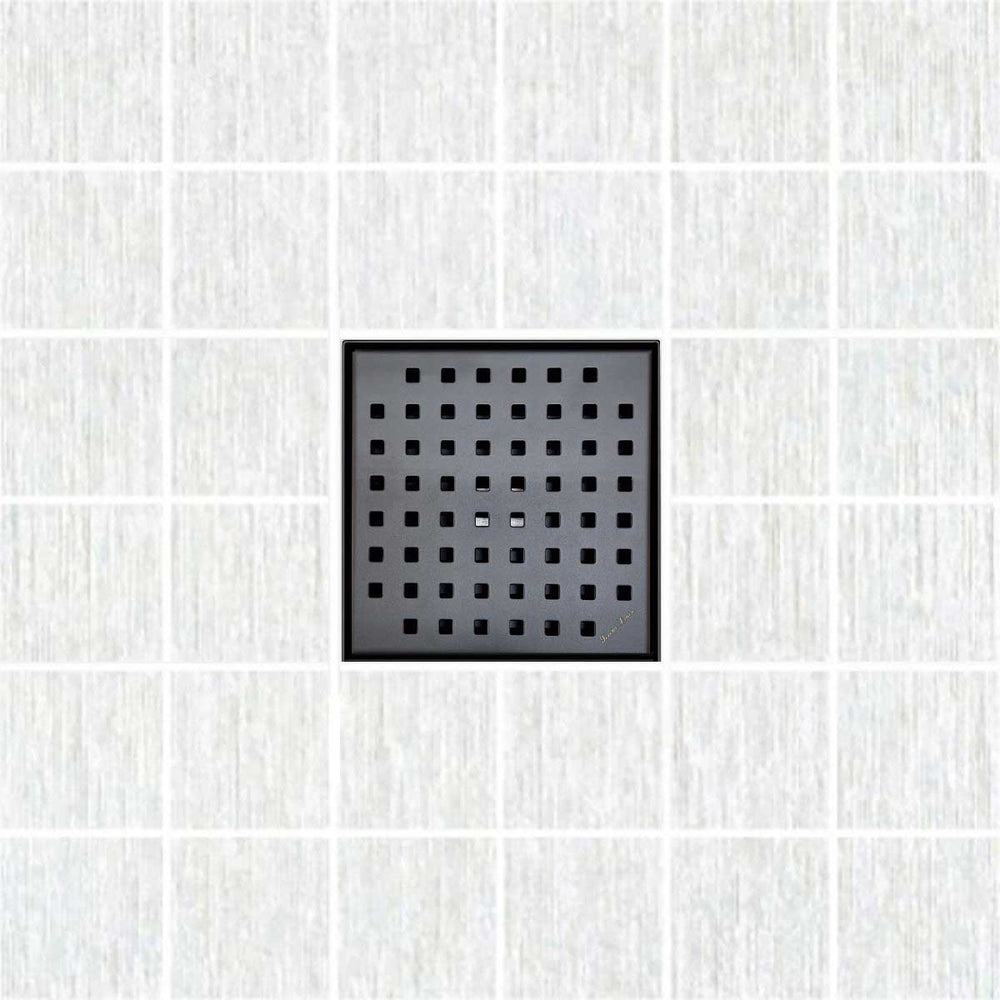 Black square drain cover on a white tiled floor