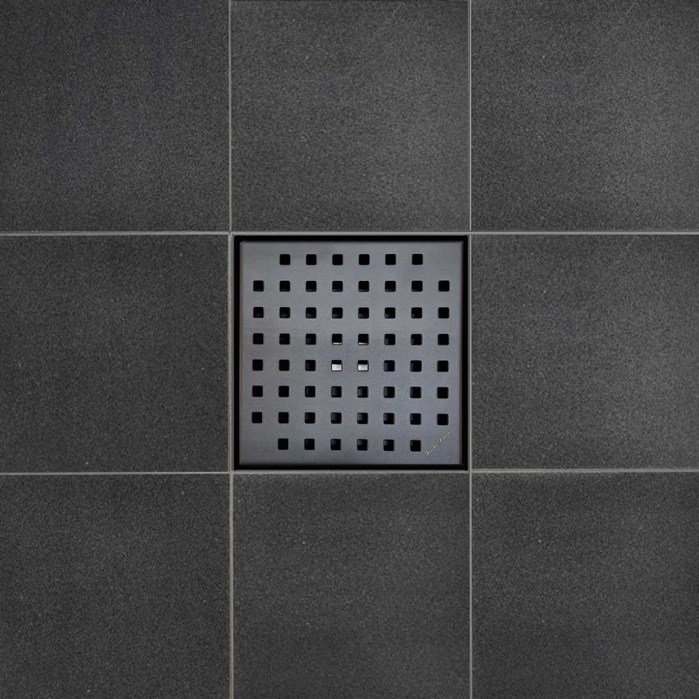 Black square drain cover on a tiled floor