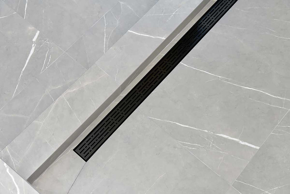 SereneDrains broken Lane Linear shower drain in Matte Black over grey tile