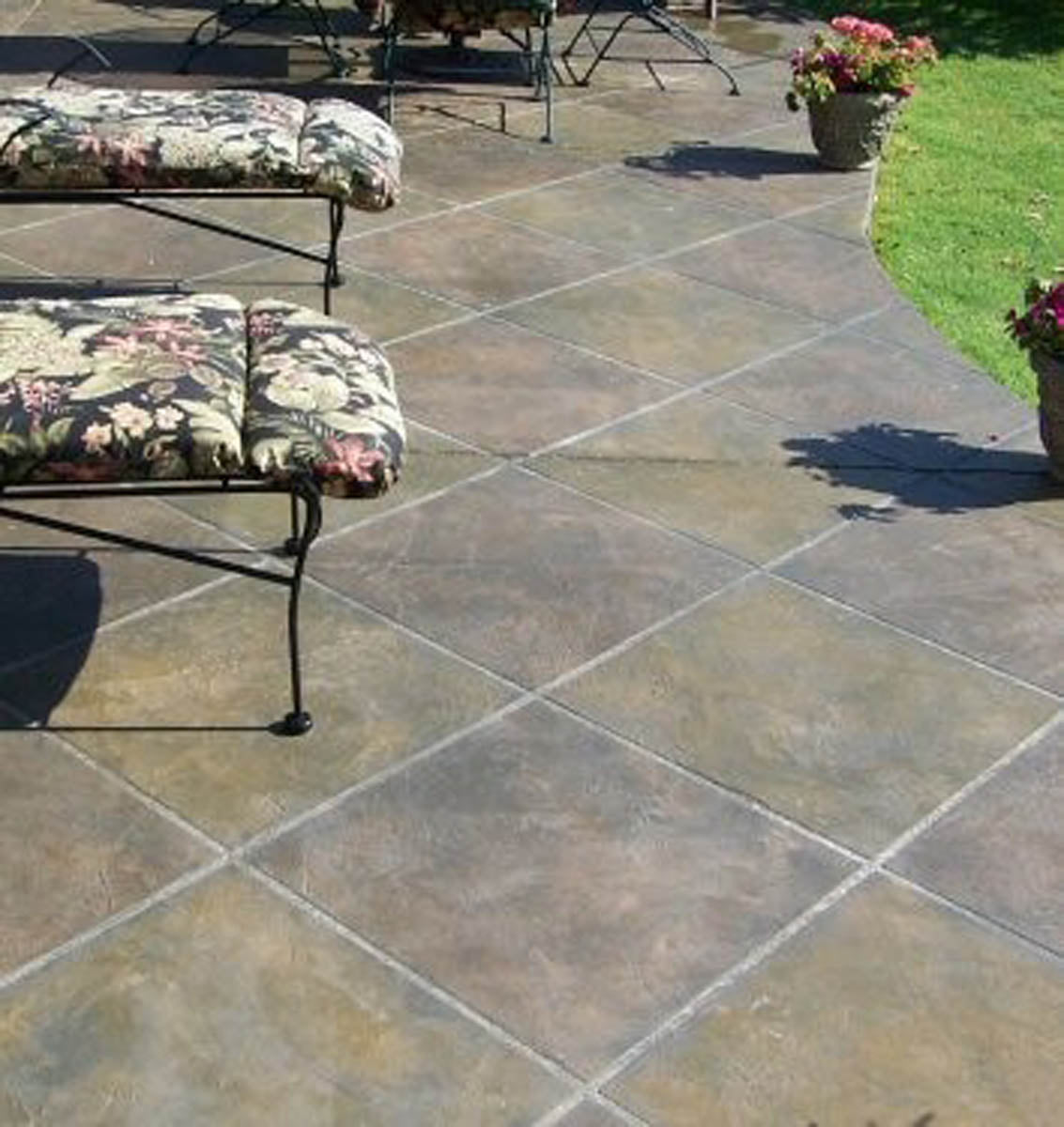 Patio with stone tiles, floral cushioned bench, and potted plants applied with Smith Paint Poly-SB