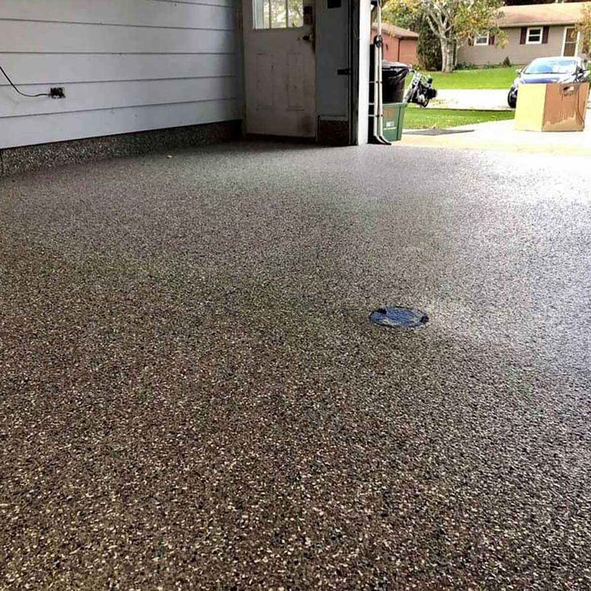 Polished concrete floor in a residential garage with visible speckles using Smith Paint Poly-SB