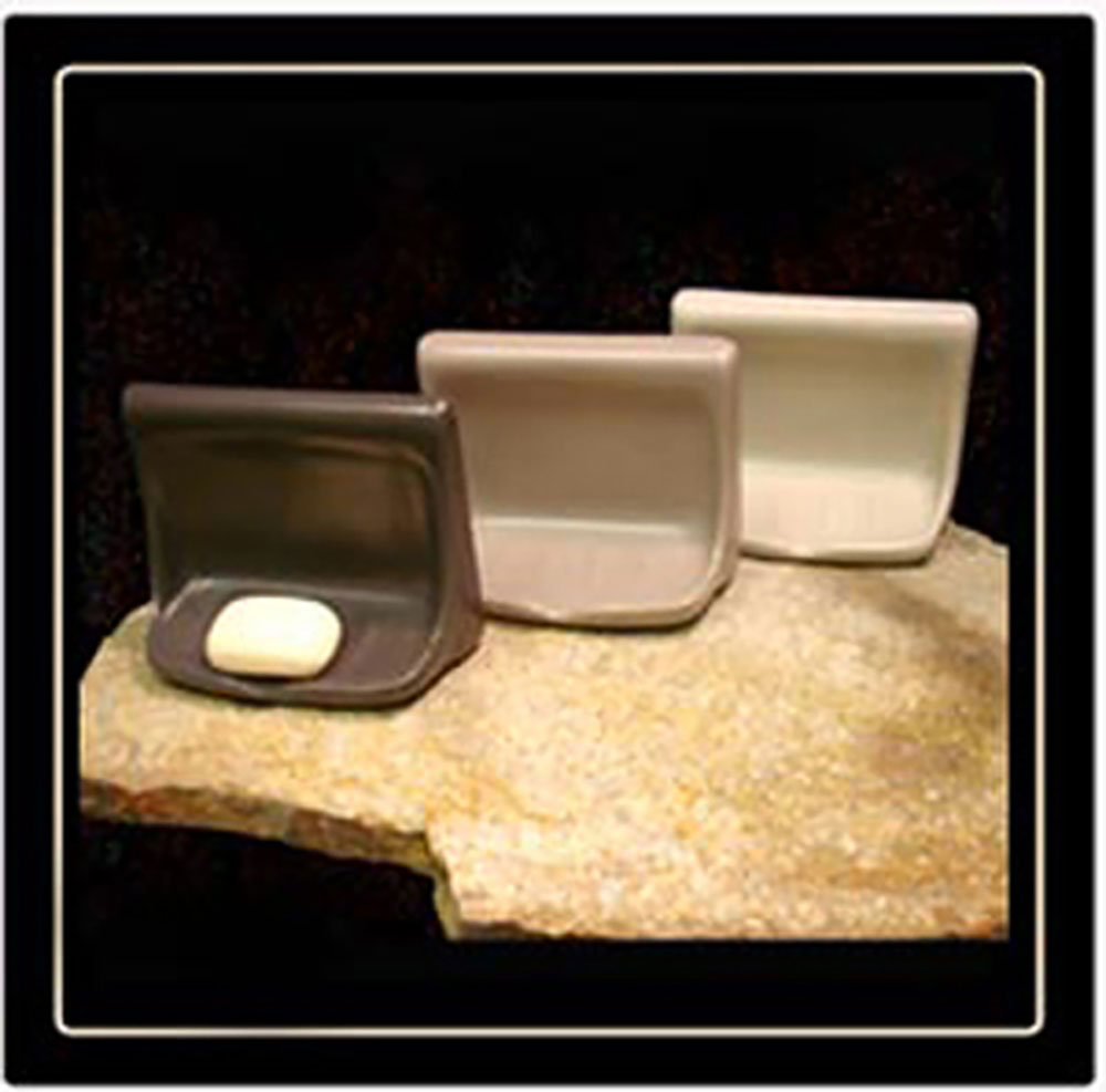 Set of three pet bowls in different sizes on a textured surface with a dark background