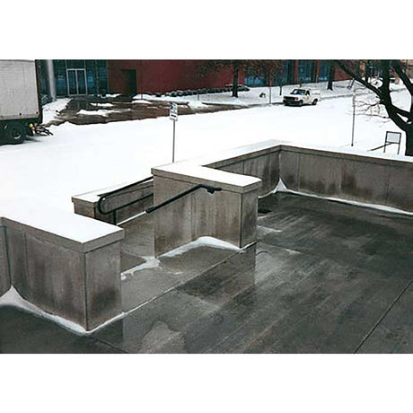 Concrete skate park with snow on the ground