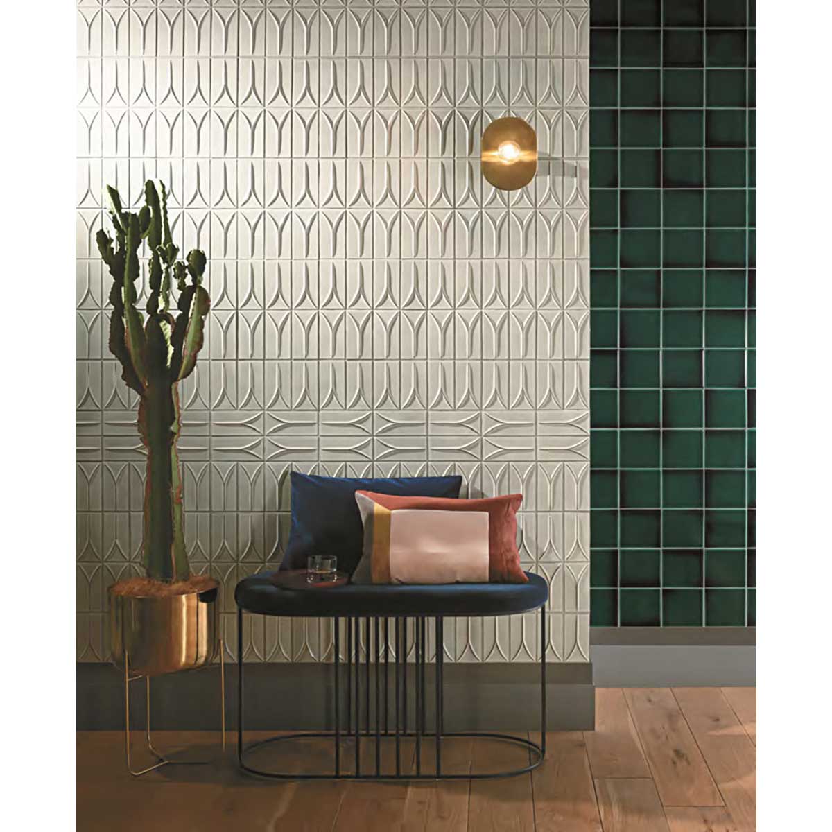 Modern interior with Takao Magnolia 3x6 3D Matte Porcelain Wall Tile, a bench with pillows, and a cactus plant.