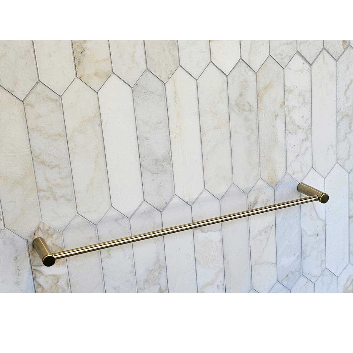 TileWare Towel Bar Promessa Series Gold towel bar mounted on a tiled wall with geometric pattern
