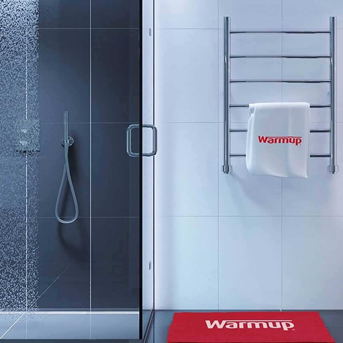 Bathroom with shower, towel rack, and mat featuring 'Warmup' brand.
