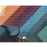 Colorful Kaleidoscope tiled wall with a blue chair and bag in front