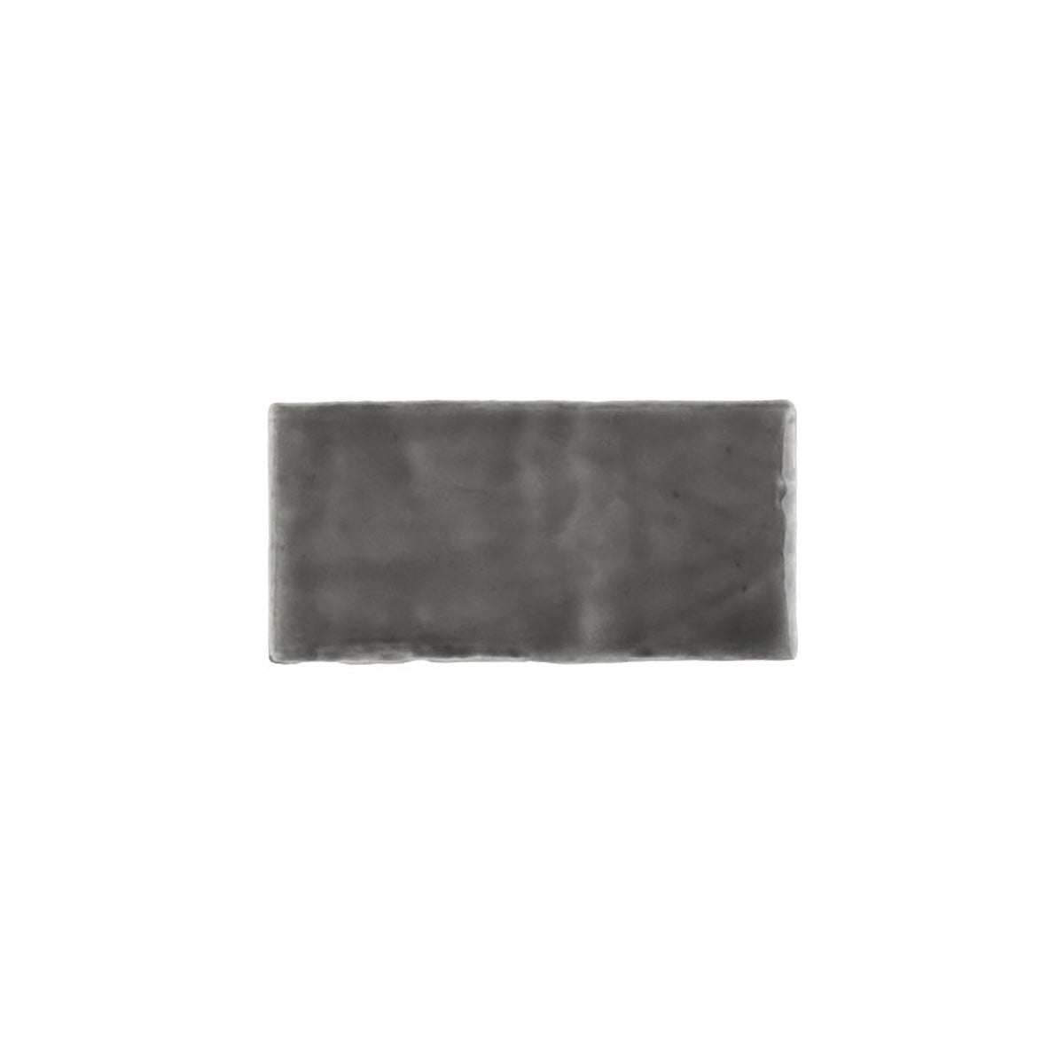 Glossy dark grey ceramic subway tile with handcrafted Spanish artisan texture