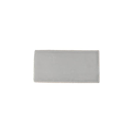 Glossy grey ceramic subway tile with handcrafted Spanish artisan detailing