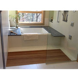 Premium teak wood mat beside modern bathtub