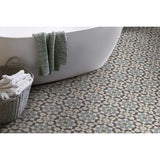 Bathroom with a freestanding bathtub, patterned floor, basket of towels and Alhambra Series Layla 8x8 Deco Porcelain Tile