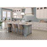 Modern kitchen with a gray island, white cabinets and Alhambra Series Layla 8x8 Deco Porcelain Tile