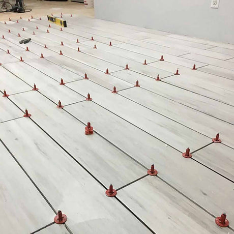 Porcelain white tile with ATR Tile Leveling System T Shape Profile Spacers in a brick Pattern 