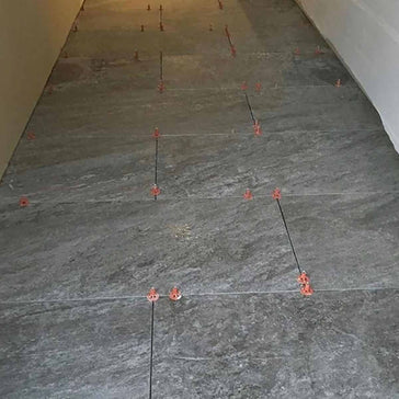 Gray tiled floor with Brick layout with Porcelain white tile with ATR Tile Leveling System T Shape Profile Spacers