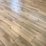 Wooden flooring with ATR Tile Leveling System T Shape Profile Spacers in a brick Pattern 