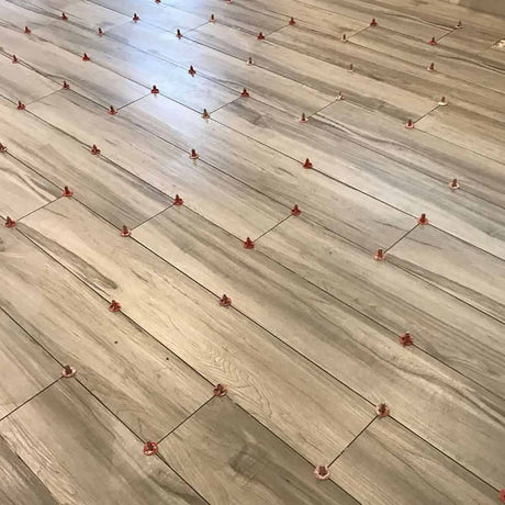 Wooden flooring with ATR Tile Leveling System T Shape Profile Spacers in a brick Pattern 