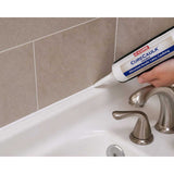 Person applying C-Cure Sanded Tile Caulking 10.2 oz to a bathroom corner with a Curecaulk tube.