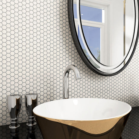 Modern bathroom with hexagonal tile pattern, freestanding bathtub, and round mirror.