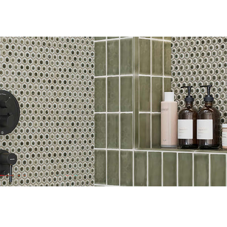 Bathroom setting with Hexagon Porcelain Mosaic Tile - Sage Green and shelves holding skincare products.