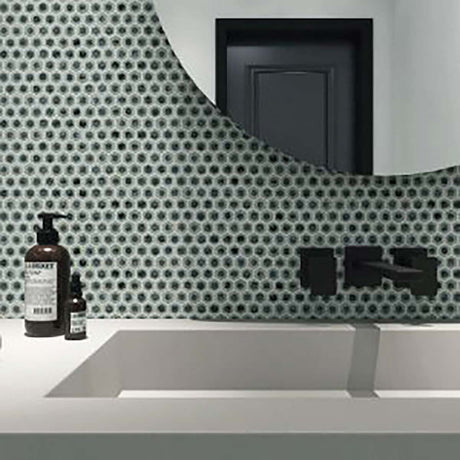 Bathroom setting with a geometric patterned wall, sink, and bottles with Hexagon Porcelain Mosaic Tile - Tropical Lush