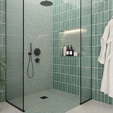 Modern bathroom with green tiled walls, glass shower enclosure, and bathrobe with Hexagon Porcelain Mosaic Tile - Tropical Lush