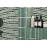 Bathroom shelf with skincare products against a Hexagon Porcelain Mosaic Tile - Tropical Lush