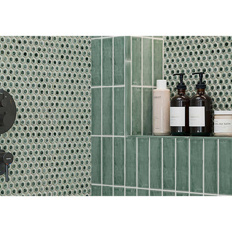 Bathroom shelf with skincare products against a Hexagon Porcelain Mosaic Tile - Tropical Lush