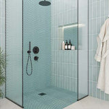 Modern bathroom with a shower area featuring Hexagon Porcelain Mosaic Tile - Mint Rose and a glass door.