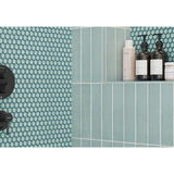 Bathroom shelf with skincare products against a Hexagon Porcelain Mosaic Tile - Mint Rose with geometric pattern