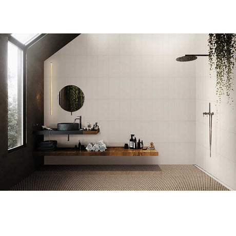 Modern bathroom with a sink, mirror, and various items on a shelf with Penny Round Porcelain Mosaic Tile - Rustic Sunset on the floor